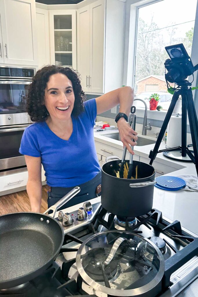 Laura Fuentes filming cooking videos in her studio kitchen