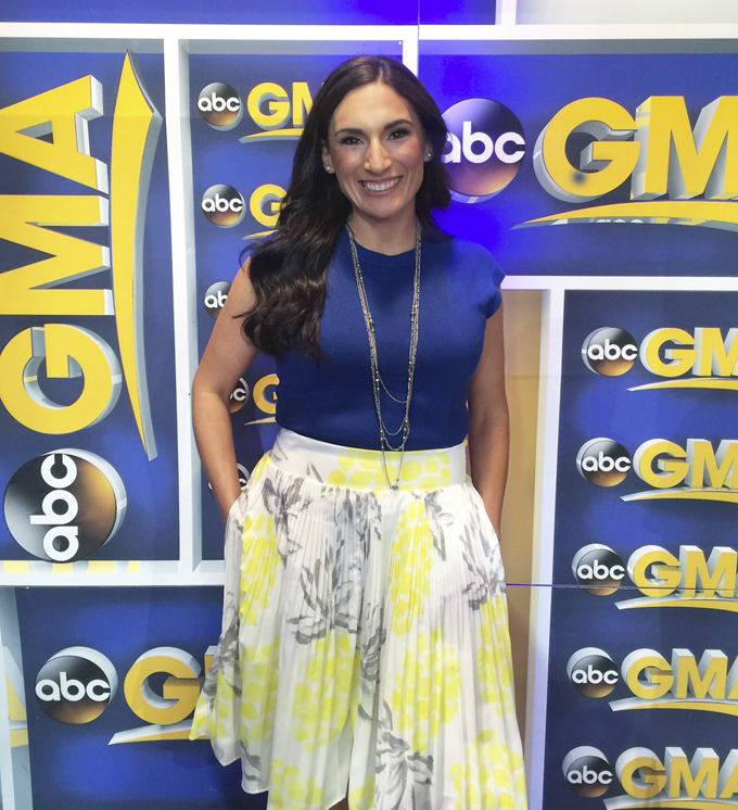 Laura fuentes Standing in front of GMA logo before going on the show